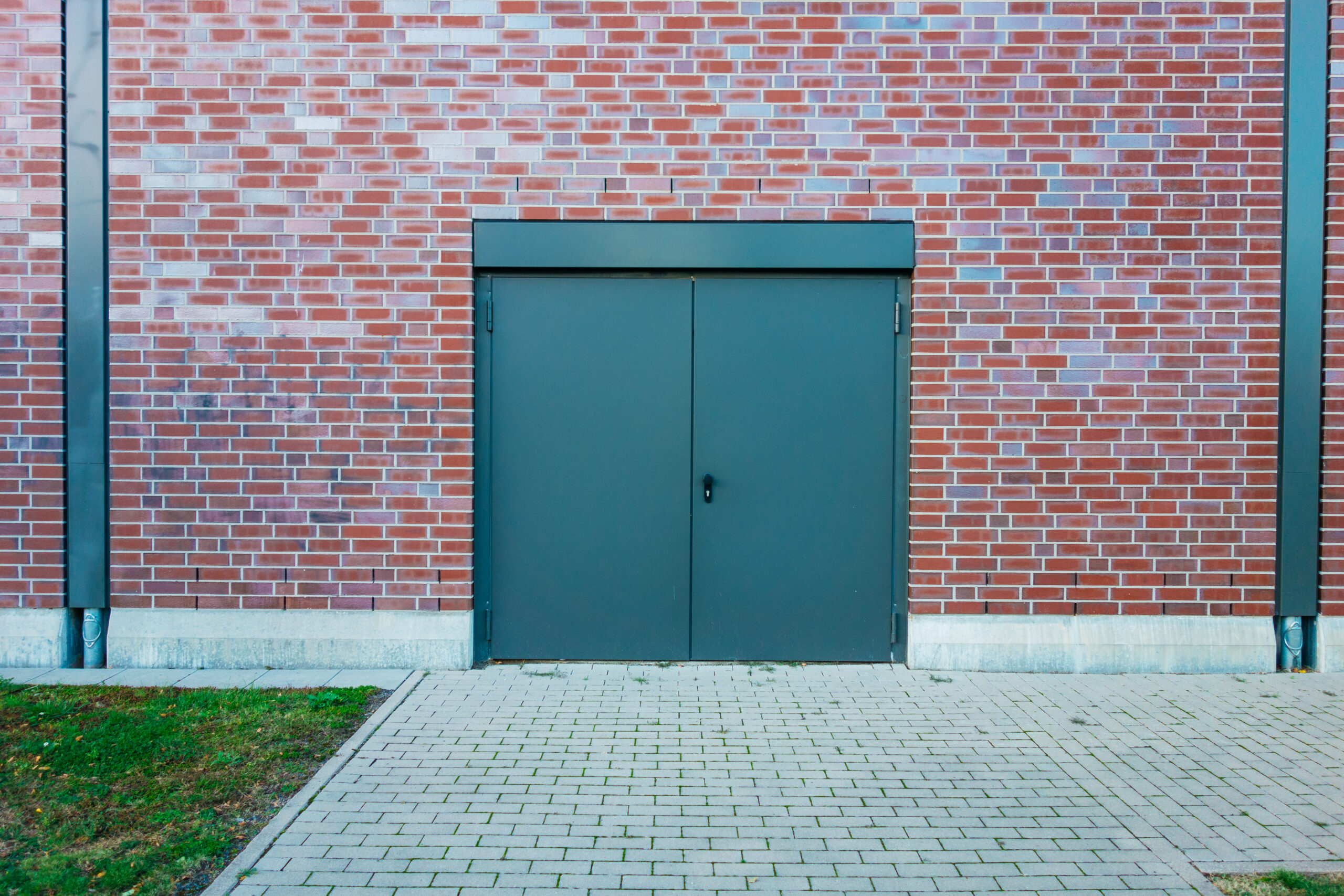 A green security door on a commercial premises