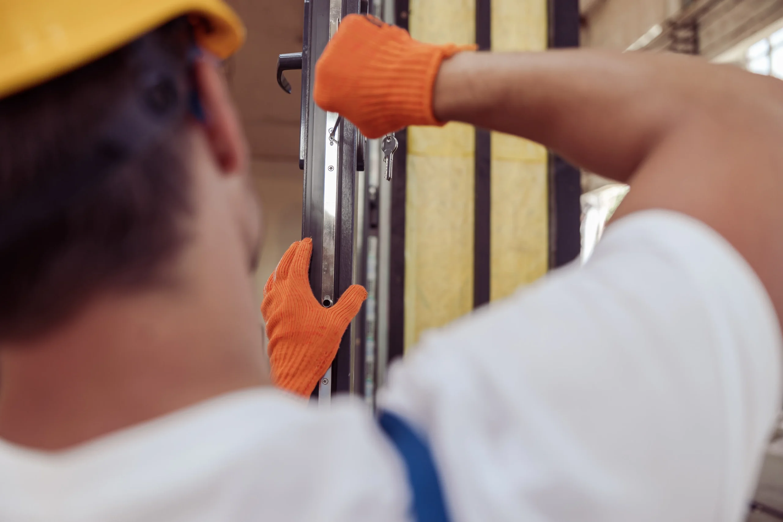 construction worker performing security door maintenance